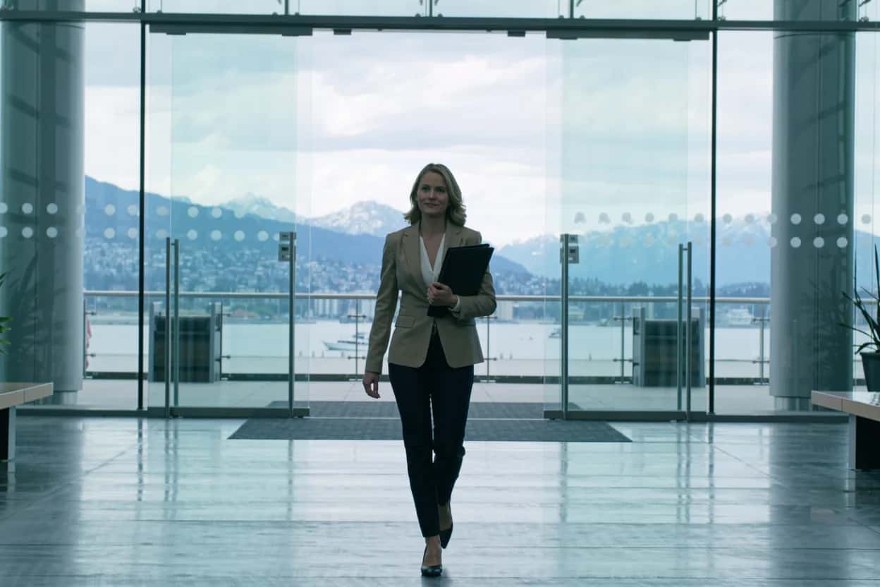 Newcomer in a downtown Vancouver office lobby researching whether she can apply for BC PNP without a job offer