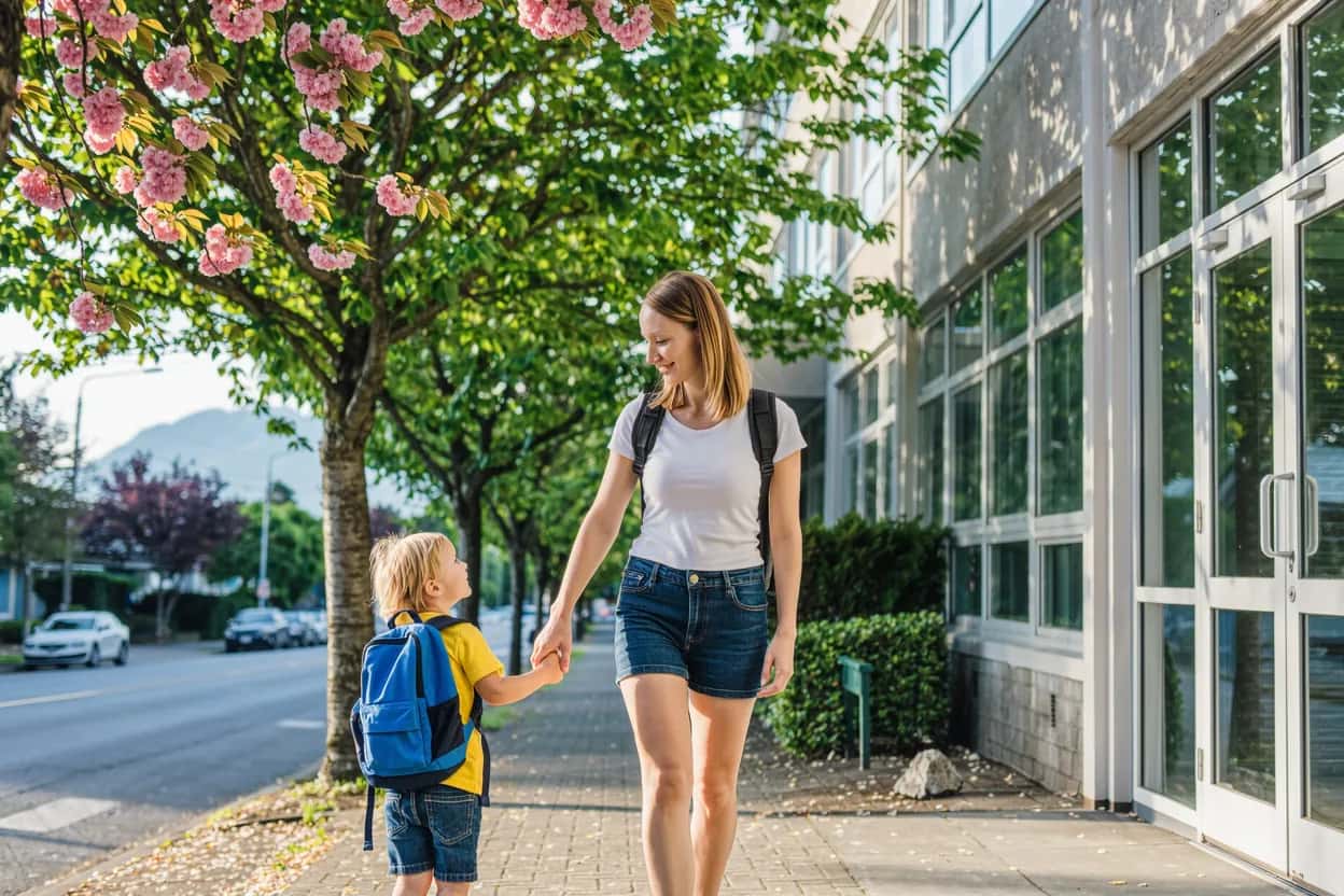 Newcomer mother walking her child to a public elementary school, part of settling into schools and childcare in Vancouver